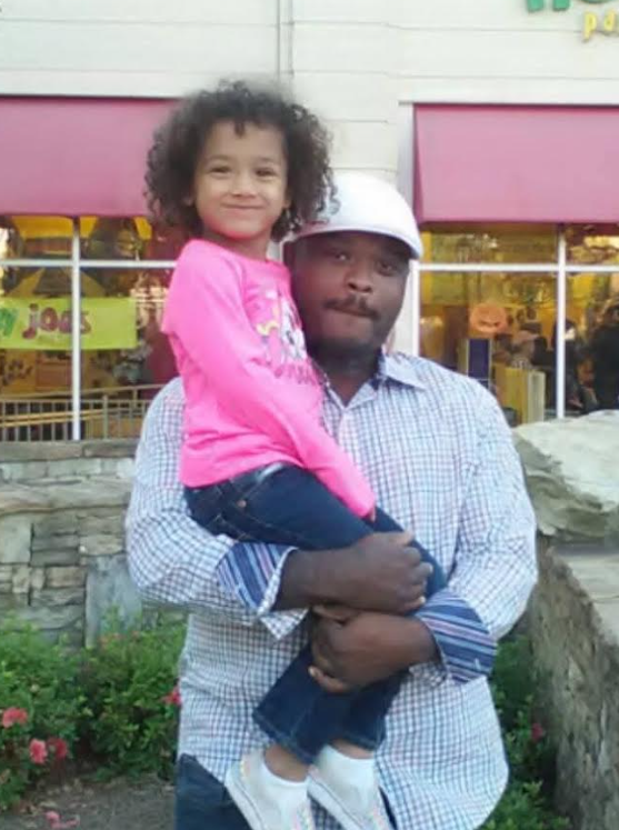 Father holding his daughter